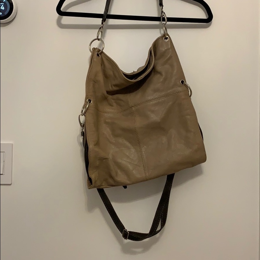 Tan and brown tote back with two straps.